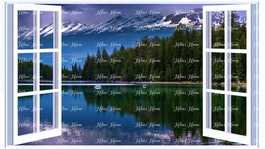 Mountains covered with snow with a forest and lake in the foreground