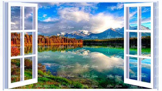 A lake with pine forest, snow covered mountains, blue sky and clouds