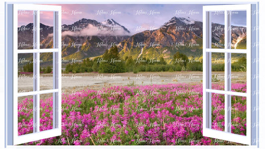 A view of mountains with a purple flower field in the foreground