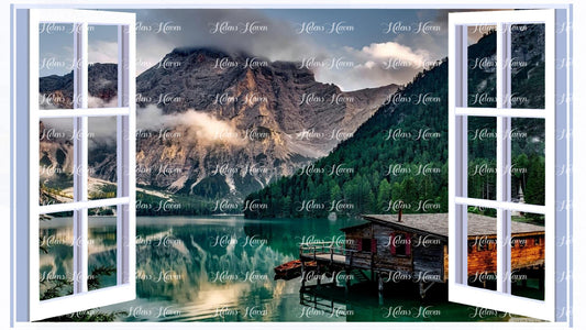 A cabin set on the edge of a lake with a snowy mountain backdrop