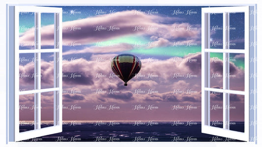 A hot air balloon dances in the sky above the sea