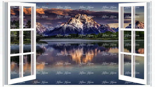 Mountains reflecting on a lake with a stormy sky approaching