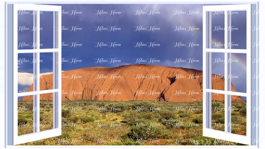 A rainbow forms in stormy skies surrounding Uluru