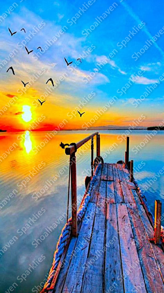 A wooden pier at sunset