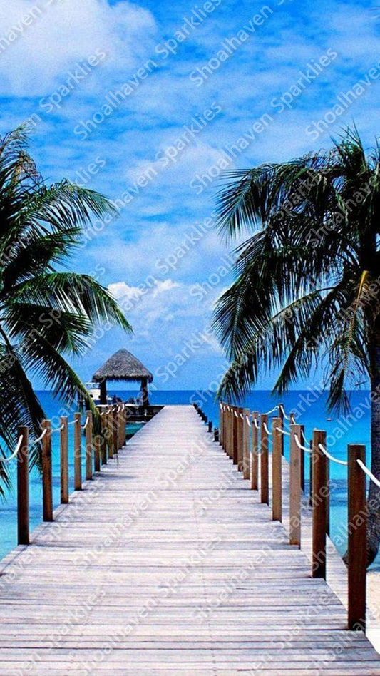 A long pier leading out into the water with a thatched hut at the end