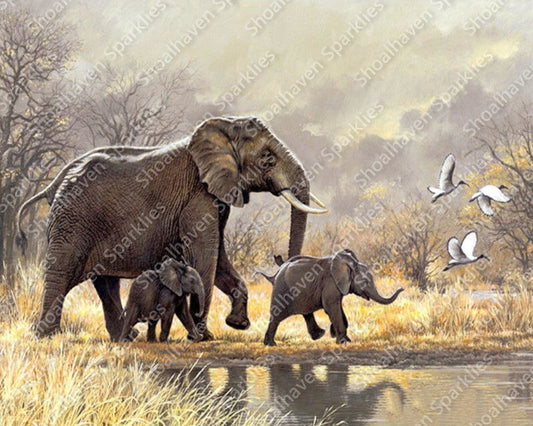 A mother elephant and two baby elepants stroll to the waterhole